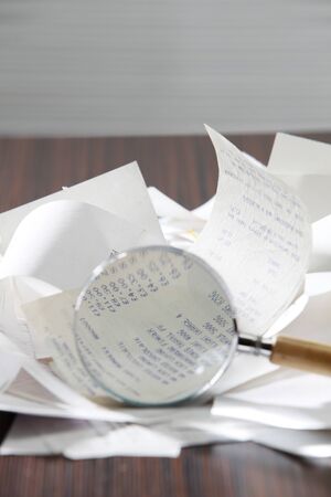 magnifier on the stack of the receipptの写真素材