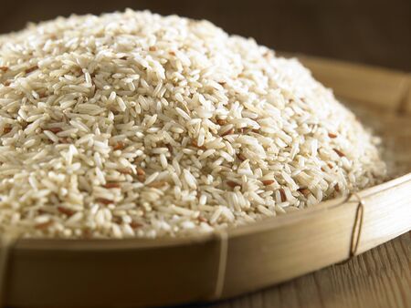 brown rice in the bamboo containnerの写真素材