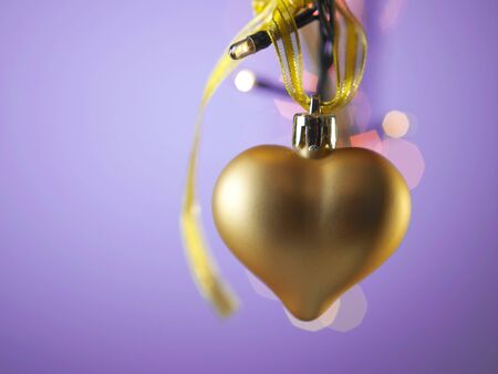 gold heart shaped christmas ornammentの写真素材