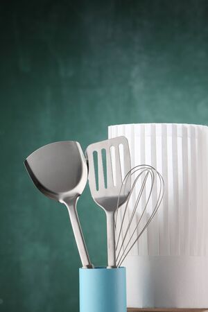 kitchen utensil and the chef's hat in front of the chalkboardの写真素材