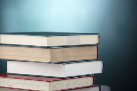 stack of books in front of black boardの写真素材