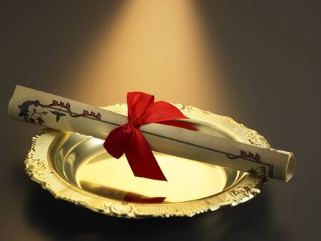 certificate with ribbon on golden trayの写真素材
