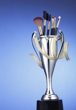 brushes in the trophy on the blue backgroundの写真素材