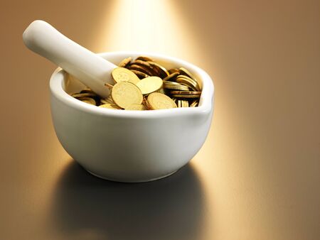 coin inside the kitchenware mortarの写真素材