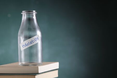 empty glass jar labelled with text educationの写真素材