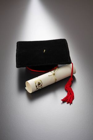 education concept of mini mortar board and certificateの写真素材