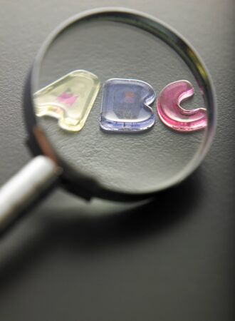 magnifying glass focus on alphabet a b cの写真素材
