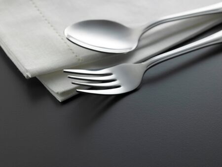 table setting fork and spoon on the napkinの写真素材