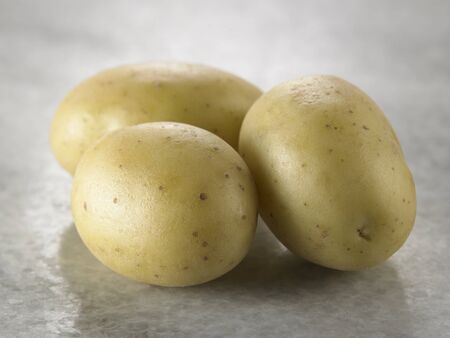 three potatoes on the marble topの写真素材