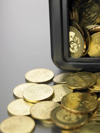 coins in front of the mini safe boxの写真素材