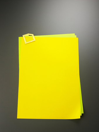 blank yellow paper with clipの写真素材