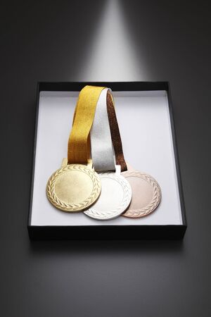 gold,silver and bronze medal in a boxの写真素材