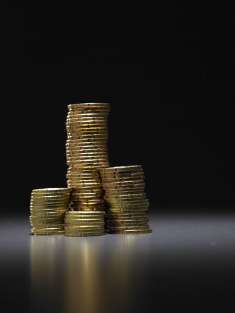 stack of coins in the dark backgroundの写真素材