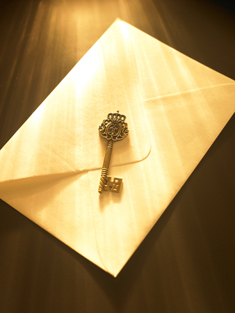 ray of light fall on key and envelopeの写真素材