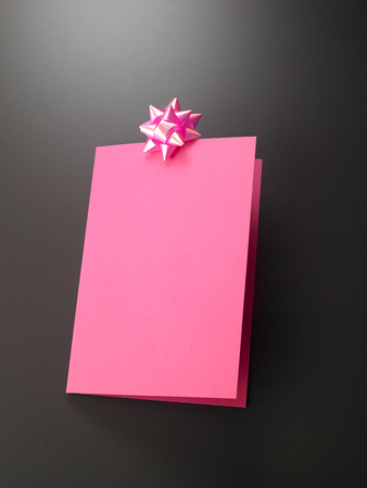 pink greeting card with ribbonの写真素材