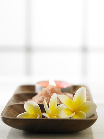 frangipani ,salt and the candle on the wooden trayの写真素材