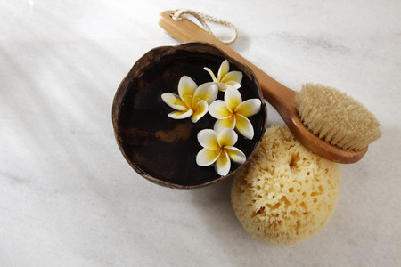 top view of sponge,brush  and bowl of flowerの写真素材
