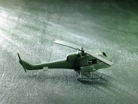 green plastic toy helicopter on the green backgroundの写真素材
