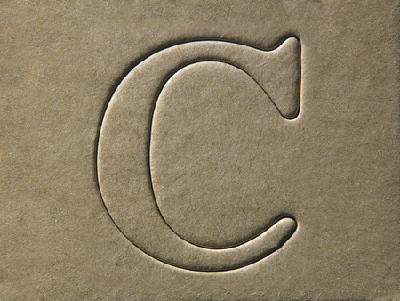 die cut alphabet c on the brown card boardの写真素材