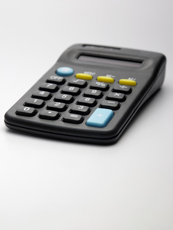 calculator and pen on the white backgroundの写真素材