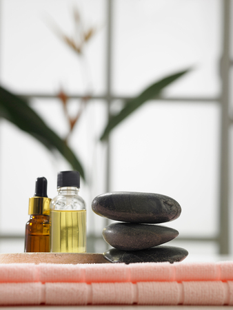 stack of stone and massage oil by the sideの写真素材