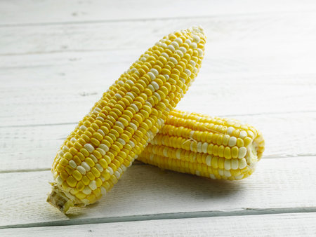 Ear of corn isolated on wooden background