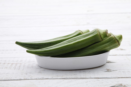 fresh lady finger on thw wooden tableの写真素材