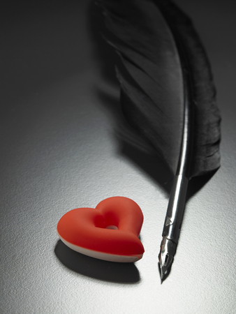 quill pen and heart shape ornamentの写真素材