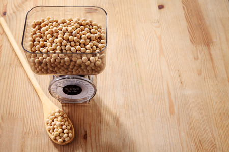 weighing the amount of soy beansの写真素材