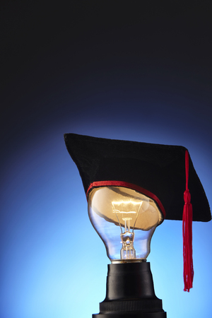 light bulb with mortar boardの写真素材