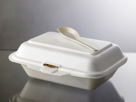 plastic spoon on top of polystrene lunch boxの写真素材