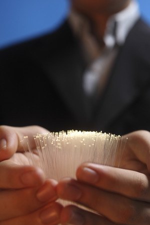 business man with bundle of  fiber opticの写真素材