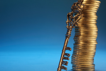 key lean on stack of the coinの写真素材