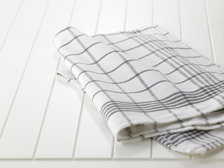 checkered napkin on wooden white  tableの写真素材