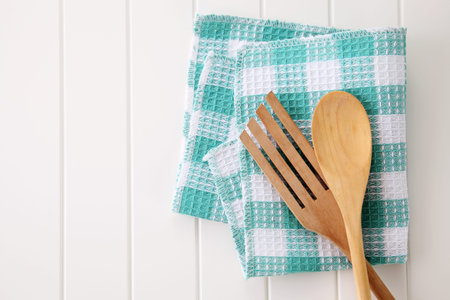wooden fork and spoon on top of the table cloth