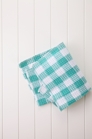 checkered napkin on wooden white  tableの写真素材