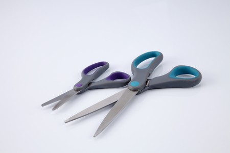 two pair of scissors which one big and small on the white backgroundの写真素材
