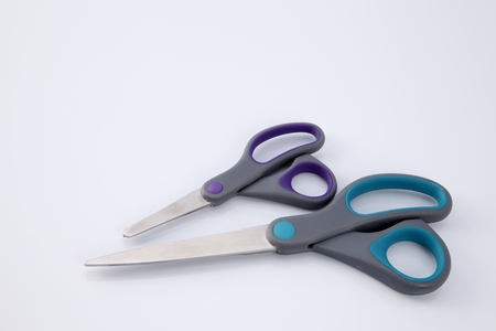 two pair of scissors which one big and small on the white backgroundの写真素材