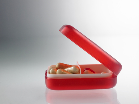 red pill box with medicineの写真素材