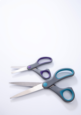 two pair of scissors which one big and small on the white backgroundの写真素材
