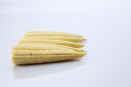 Baby corn on a white background, close-upの写真素材