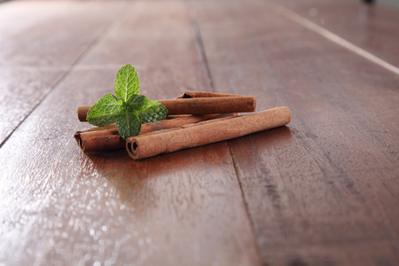 Mint with cinnamon on the wooden tableの写真素材