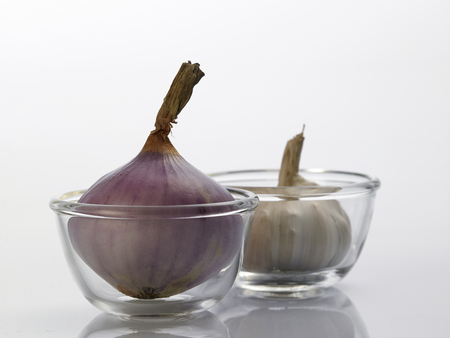 Onion and garlic clove isolated on white backgroundの写真素材