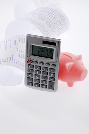 piggy bank and calculator on the white backgroundの写真素材