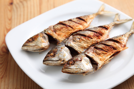 deep fried ikan kembung on the wooden tableの写真素材