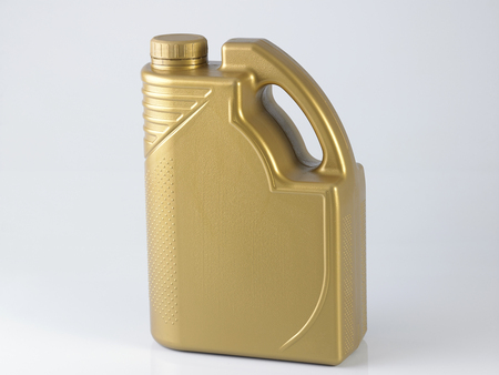 golden canister with engine oil on white backgroundの写真素材