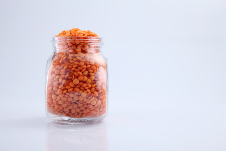 bottle of red lentils on the white backgroundの写真素材