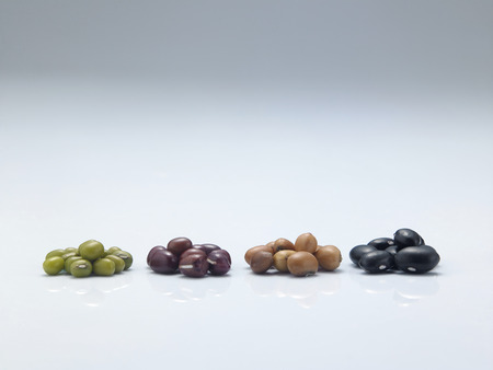 assorted beans arranged in a rowの写真素材