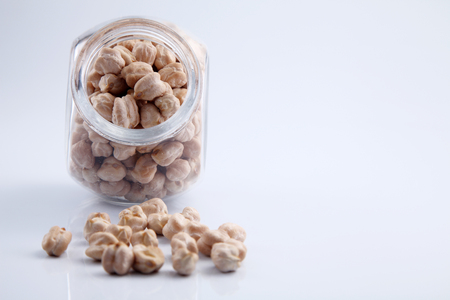 Bulk chick peas in a glass containerの写真素材