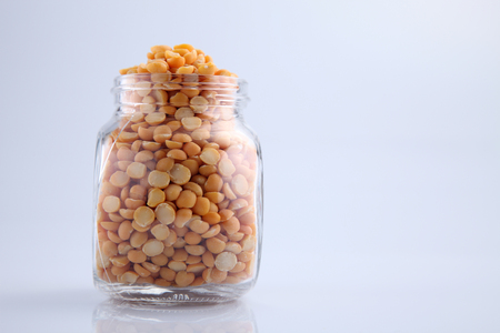 uncooked indian dhal lentil in a glass containerの写真素材